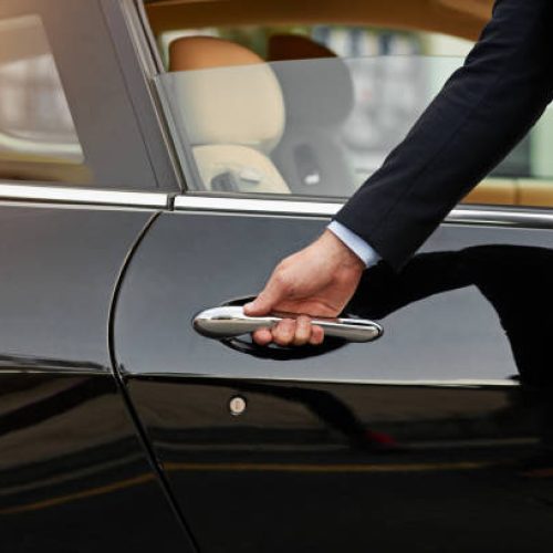 Cropped shot of an unrecognizable male chauffeur opening a car door